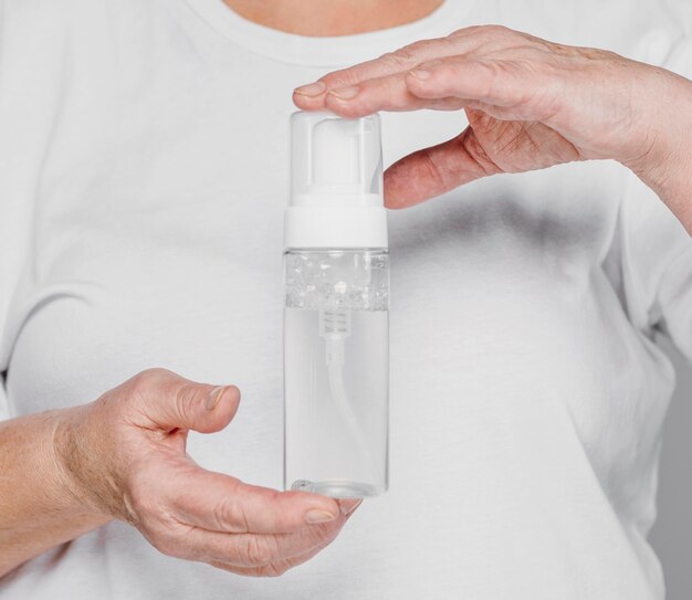 Close-up hands holding serum bottle