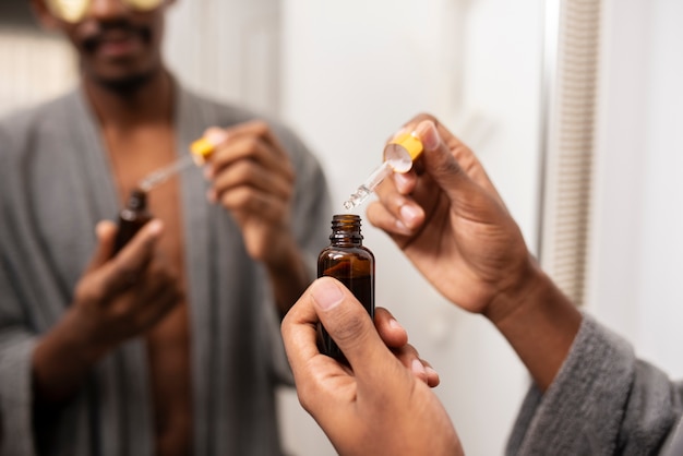 Close up hands holding serum bottle