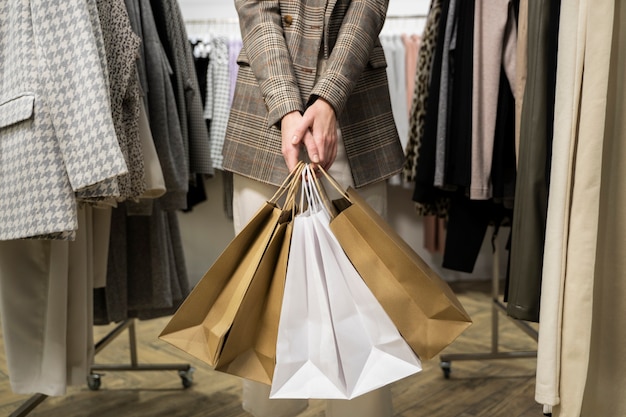 close up hands holding shopping bags