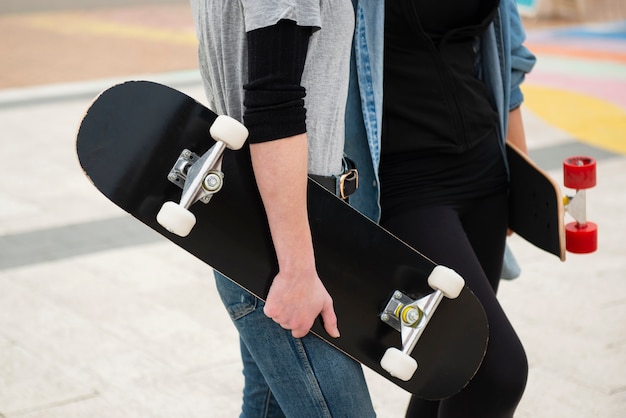 Close up hands holding skateboards