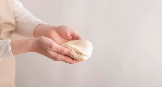 Free photo close-up hands holding small dough