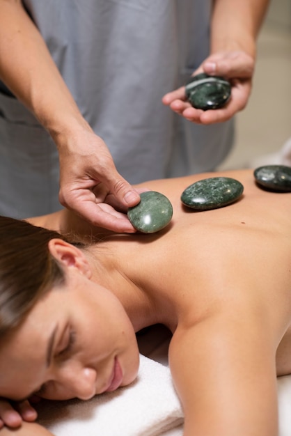 Free photo close up hands holding spa stones