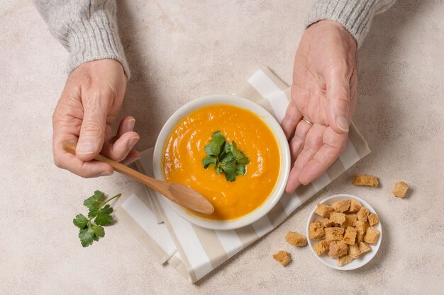 Close-up hands holding spoon and bowl