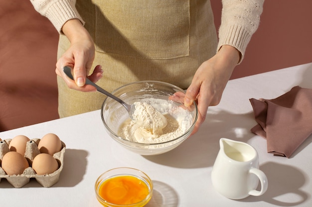 Close up hands holding spoon and bowl