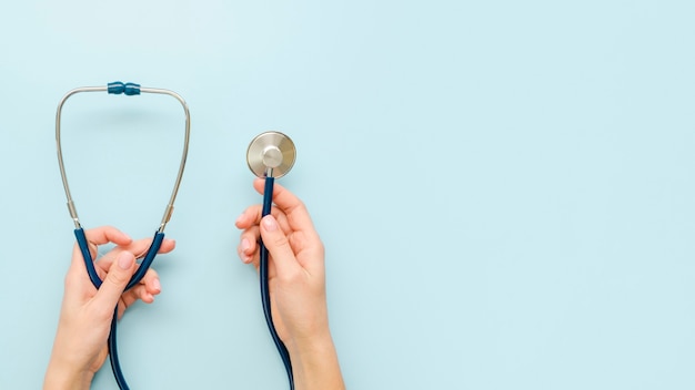 Close-up hands holding stethoscope