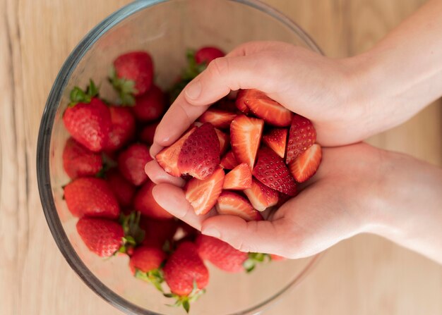 Close up hands holding strawberries