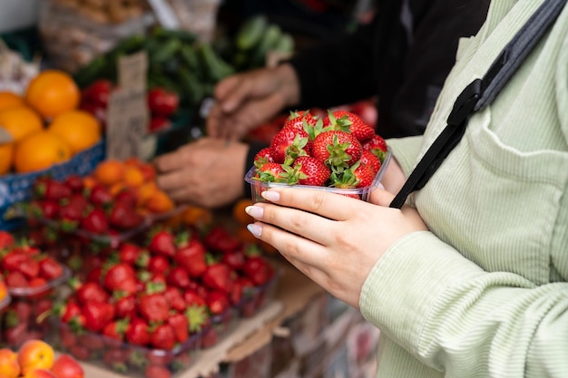 Free photo close up hands holding strawberries