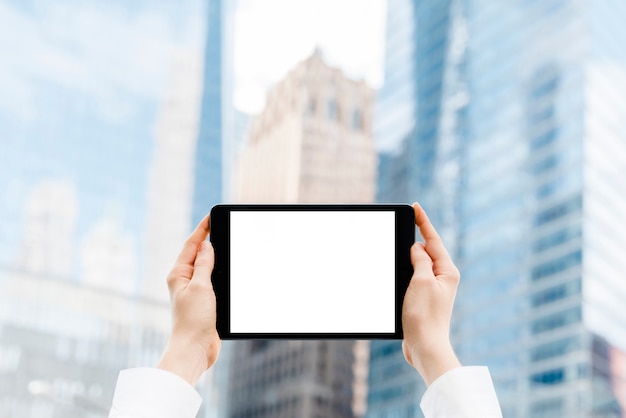 Close-up hands holding a tablet mock-up