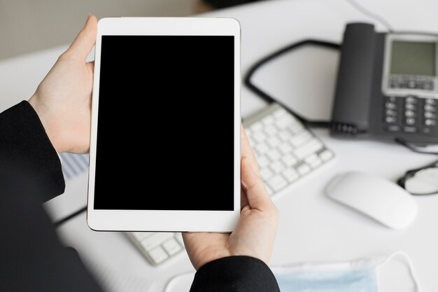 Close-up hands holding tablet