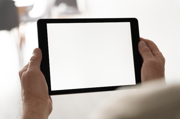 Close up hands holding tablet