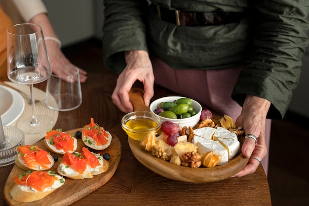 Close up hands holding tasty food board