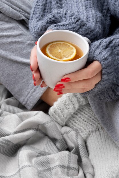 Close up hands holding tea cup