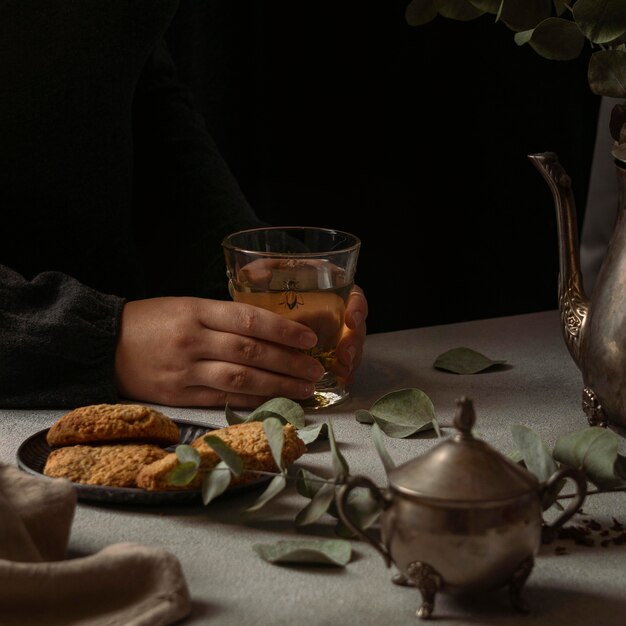 Close-up hands holding tea glass