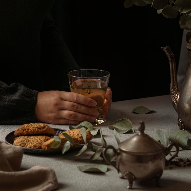 close-up hands holding tea glass