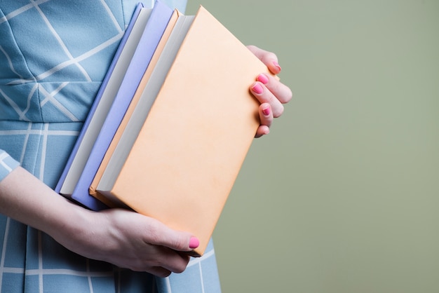 Close-up of hands holding two books