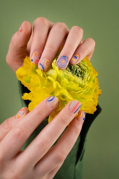 Close up hands holding yellow flower