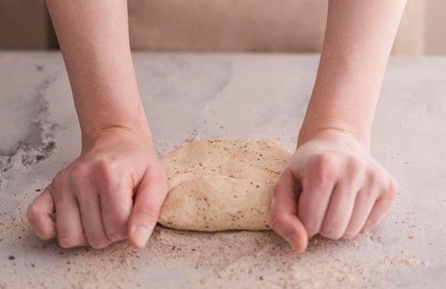 Free photo close-up hands kneading dough