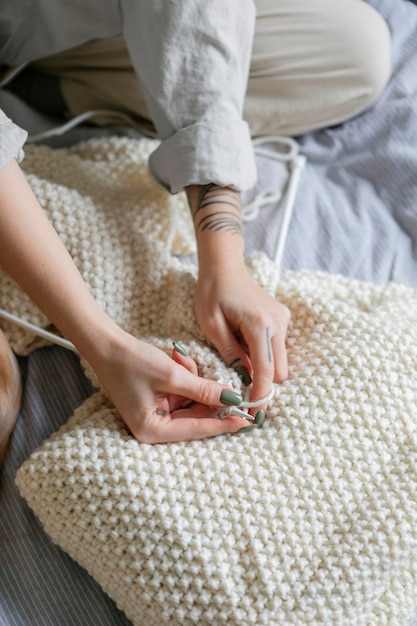 Close up hands knitting at home