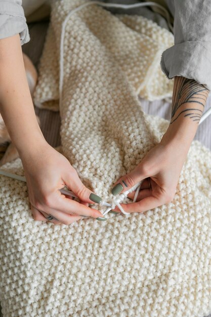 Close up hands knitting scarf