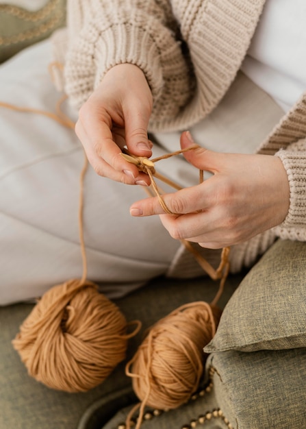 Close-up hands knitting with yarn