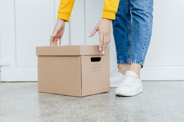 Close-up hands lifting box