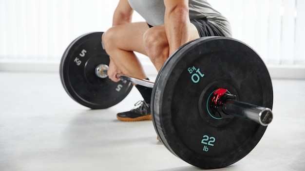 Close-up hands lifting weight indoors