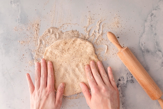 Free photo close-up hands making dough top view