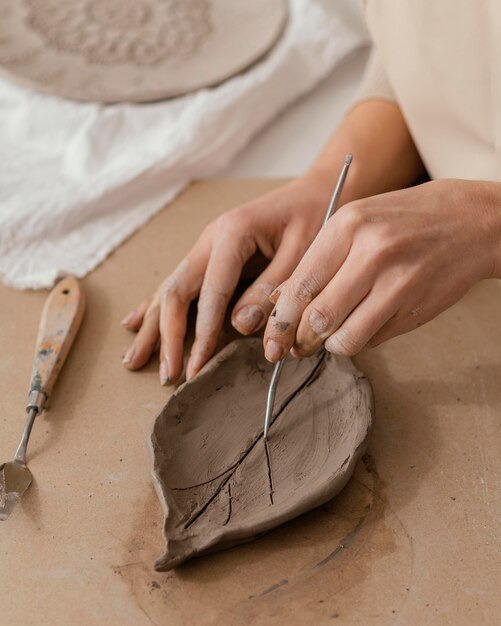 Close-up hands making leaf