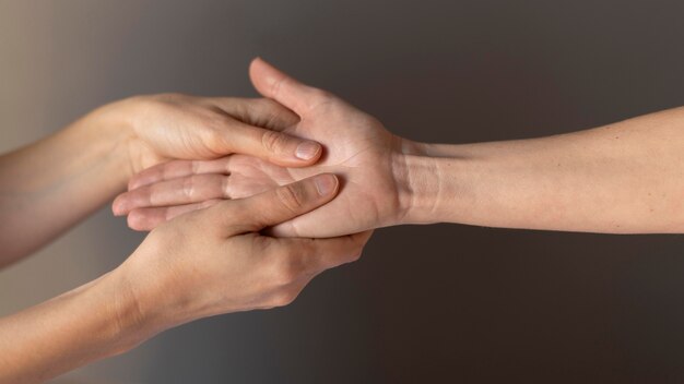 Close-up hands massaging palm