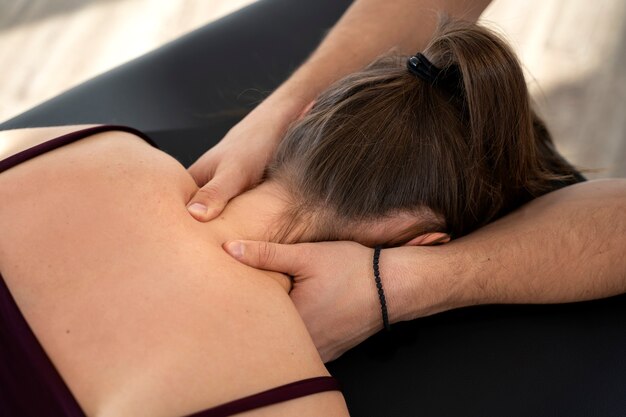 Close up hands massaging patient's neck