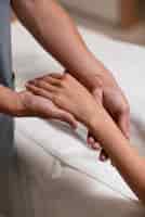 Free photo close up hands massaging patient