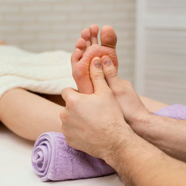 Close up hands massaging sole