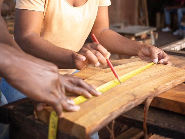 Close up hands measuring wood