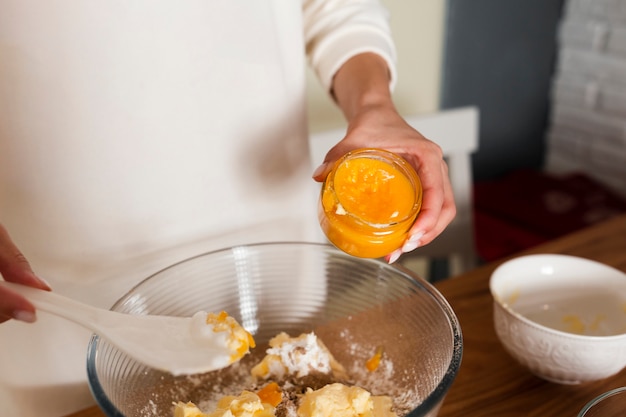 Close-up of hands mixing ingredients in bowl