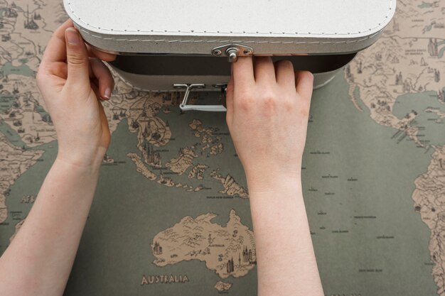 Close-up of hands opening a suitcase
