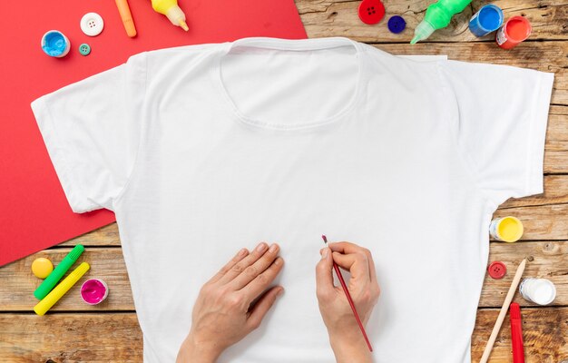 Close-up hands painting shirt
