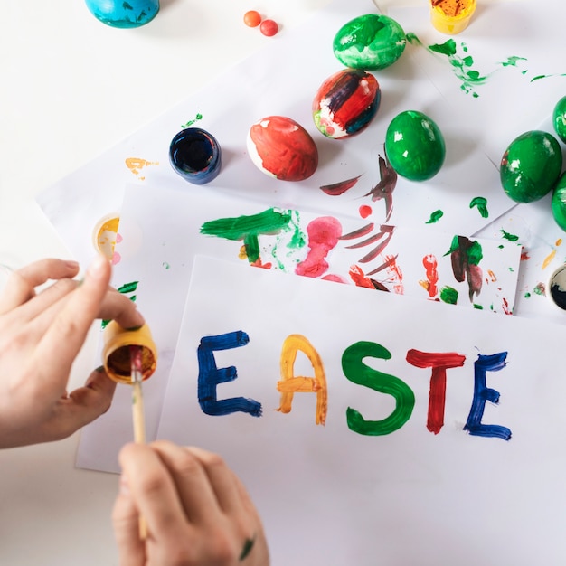 Close-up hands painting traditional easter eggs