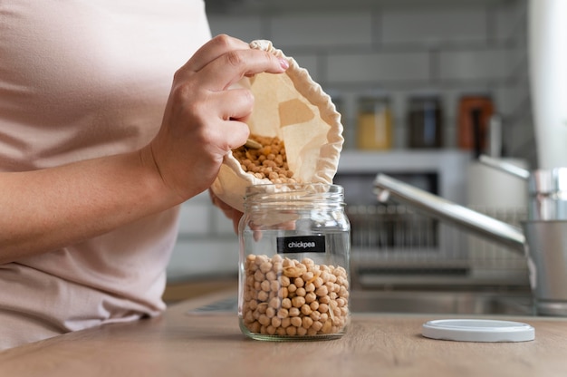 close up  hands pouring chickpeas from bag