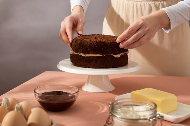 Close up hands preparing cake