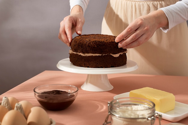 Close up hands preparing cake