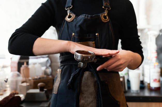 Foto gratuita chiudere le mani che preparano il caffè