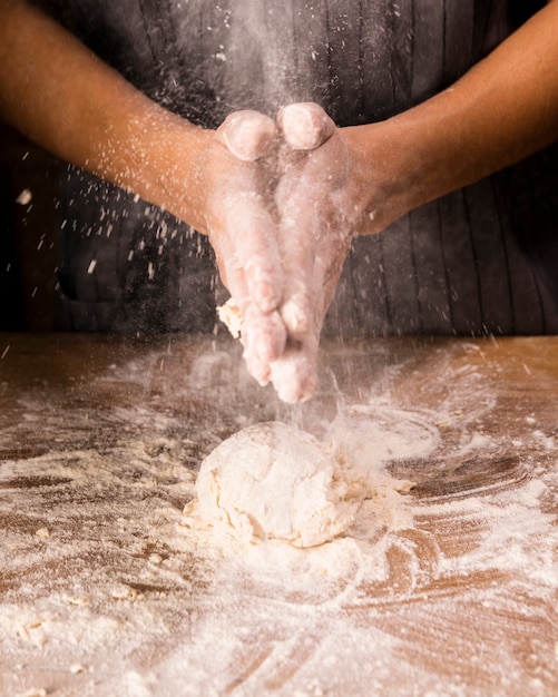 Close-up hands preparing dough