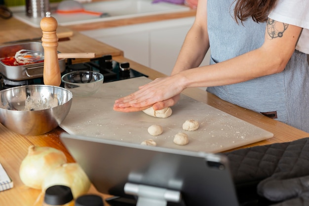 Close up hands preparing dough