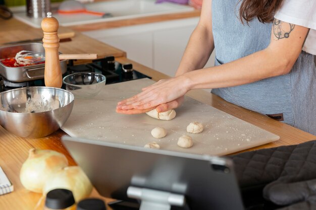 Close up hands preparing dough