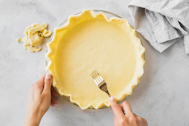 Close-up hands preparing pie