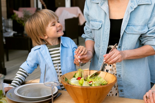 Close up hands preparing salad