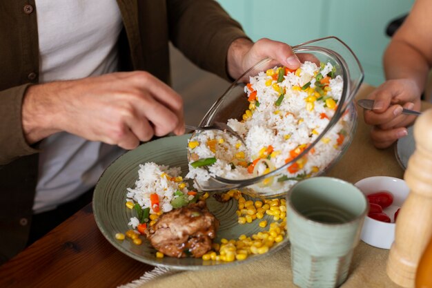 Close up hands putting food on plate