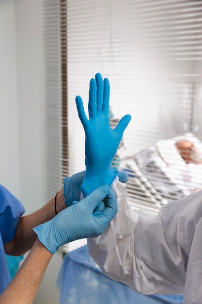 Close up hands putting on glove