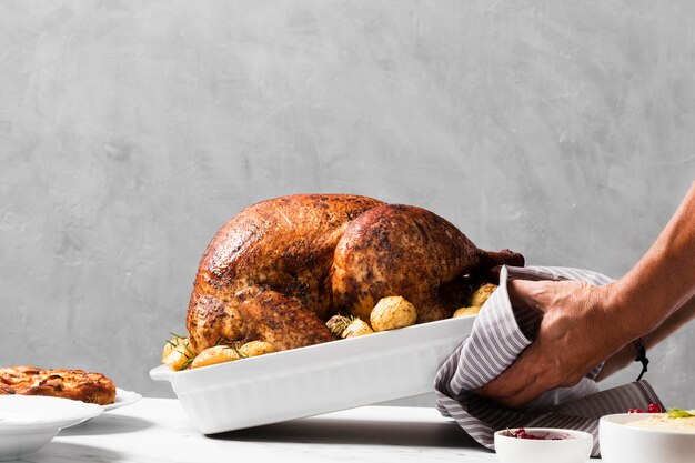 Close-up hands putting turkey on table