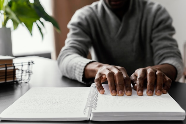 Free photo close up hands reading braille